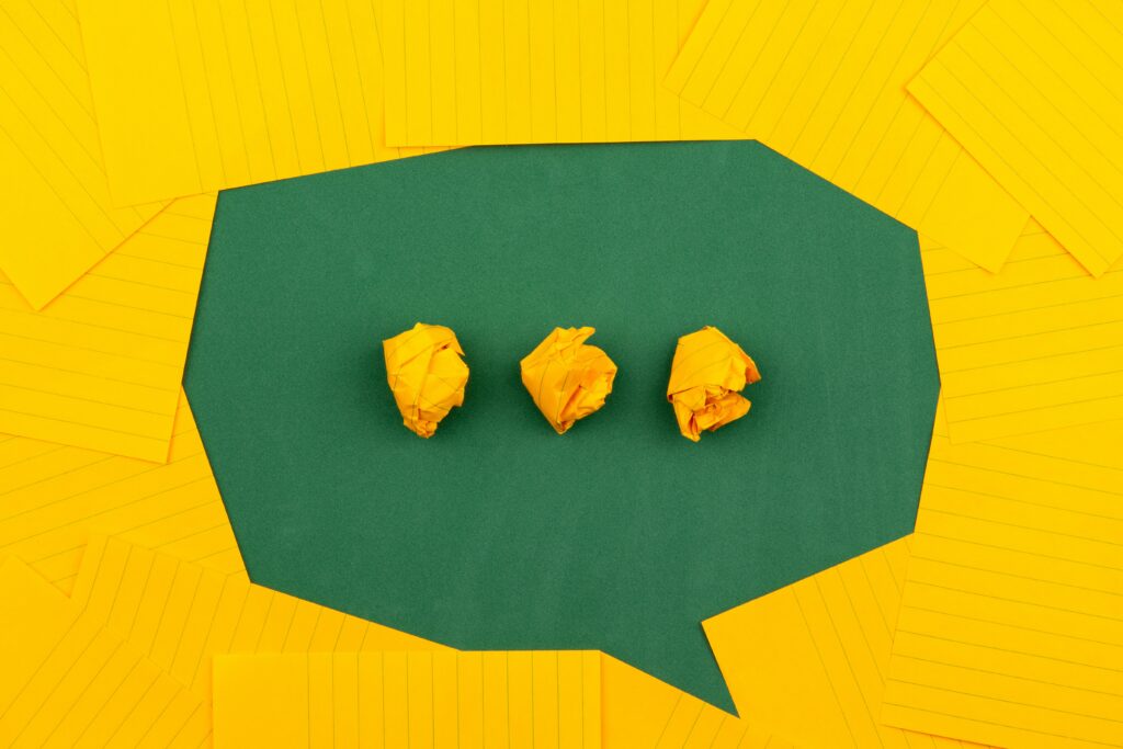 A message bubble made of green and yellow paper.
